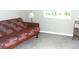 Cozy room with neutral carpet, a futon, and a window allowing natural light at 11774 Tempest Harbor Loop, Venice, FL 34292