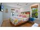 Main bedroom with floral bedding, ceiling fan, and hardwood floors at 117 88Th Ave, Treasure Island, FL 33706