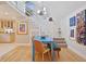Bright dining room with blue table, hardwood floors, and artwork on the walls at 117 88Th Ave, Treasure Island, FL 33706