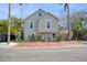 Charming two-story house with brick pavers and a lush, tropical landscape at 117 88Th Ave, Treasure Island, FL 33706