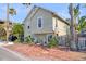 Two-story house with brick walkway, tropical landscaping, and a wood fence at 117 88Th Ave, Treasure Island, FL 33706