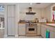 Kitchen with stainless steel range, microwave, and light-colored cabinets at 117 88Th Ave, Treasure Island, FL 33706
