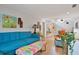Bright and airy living room features a teal sofa and colorful coffee table at 117 88Th Ave, Treasure Island, FL 33706