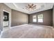 Bright bedroom with ceiling fan and en-suite bathroom at 8235 Bird Whistle Ln, Land O Lakes, FL 34637