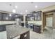 Modern kitchen with granite countertops, stainless steel appliances, and dark cabinets at 8235 Bird Whistle Ln, Land O Lakes, FL 34637