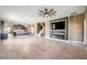 Open living room with fireplace, kitchen island view, and wood-look tile floors at 8235 Bird Whistle Ln, Land O Lakes, FL 34637