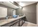 Double vanity bathroom with granite countertops and dark cabinets at 8235 Bird Whistle Ln, Land O Lakes, FL 34637