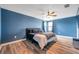 Bright main bedroom featuring a plush bed and blue walls at 8235 Bird Whistle Ln, Land O Lakes, FL 34637