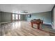 Large game room with wood-look floors and a pool table at 8235 Bird Whistle Ln, Land O Lakes, FL 34637