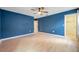 Spacious bedroom with light wood flooring and blue walls at 8235 Bird Whistle Ln, Land O Lakes, FL 34637