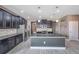 Open concept kitchen with large island and dark cabinetry at 8235 Bird Whistle Ln, Land O Lakes, FL 34637
