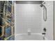 Clean bathroom with white tile, a bathtub, and a patterned shower curtain at 8235 Bird Whistle Ln, Land O Lakes, FL 34637