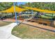 Community playground with swings and shade structure at 8235 Bird Whistle Ln, Land O Lakes, FL 34637