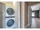 Convenient laundry room with stackable washer and dryer, and access to hallway at 8235 Bird Whistle Ln, Land O Lakes, FL 34637