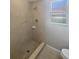 Bathroom featuring a walk-in shower with tiled surround and a neutral-colored vanity at 3184 Wessex Way, Clearwater, FL 33761