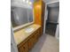 Bathroom featuring a granite countertop, vanity, a mirror, and access to bedroom at 3184 Wessex Way, Clearwater, FL 33761
