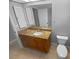 Bathroom featuring granite vanity, a large mirror, and neutral tones, creating a clean and functional space at 3184 Wessex Way, Clearwater, FL 33761