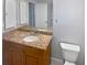 Modern bathroom with a wooden vanity and granite countertops offers a touch of elegance and functionality at 3184 Wessex Way, Clearwater, FL 33761
