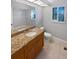 Bathroom with a wooden vanity and granite countertops offers a touch of elegance and functionality at 3184 Wessex Way, Clearwater, FL 33761