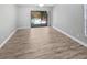 Bright bedroom with wood floors, a ceiling fan, and a sliding glass door to the pool at 3184 Wessex Way, Clearwater, FL 33761