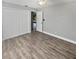 Bedroom with neutral walls, new floors, a ceiling fan, and double closets, providing comfort and ample storage at 3184 Wessex Way, Clearwater, FL 33761