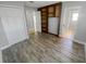 Comfortable bedroom with wood-look flooring and a built-in shelf provides a welcoming and practical living space at 3184 Wessex Way, Clearwater, FL 33761