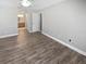 Bedroom with wood floors and doorway to ensuite bathroom at 3184 Wessex Way, Clearwater, FL 33761