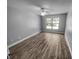 A bright bedroom features new flooring, ceiling fan, and a sunny window at 3184 Wessex Way, Clearwater, FL 33761