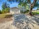 Inviting one-story home with a two-car garage, mature trees, and a well-maintained lawn adding to its curb appeal at 3184 Wessex Way, Clearwater, FL 33761