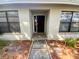 Inviting front entrance with neutral paint and clean landscape features to create curb appeal at 3184 Wessex Way, Clearwater, FL 33761