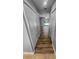 Hallway with wood floors, closet and view of the living room with sliding glass doors and a pool outside at 3184 Wessex Way, Clearwater, FL 33761