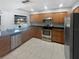 Spacious kitchen features stainless steel appliances, tiled floors, and wood cabinets at 3184 Wessex Way, Clearwater, FL 33761