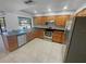 Kitchen features stainless steel appliances, granite countertops, and wood cabinetry at 3184 Wessex Way, Clearwater, FL 33761