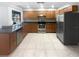 Spacious kitchen features stainless steel appliances, tiled floors, and wood cabinets at 3184 Wessex Way, Clearwater, FL 33761