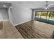 Open living room with new floors and sliding glass doors to the pool area, blending indoor and outdoor spaces at 3184 Wessex Way, Clearwater, FL 33761