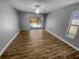 Bright living room with hardwood floors and sliding glass doors to the pool, perfect for indoor-outdoor living at 3184 Wessex Way, Clearwater, FL 33761