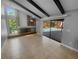 Open concept living room features a brick fireplace and sliding doors to the pool at 3184 Wessex Way, Clearwater, FL 33761