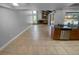 Spacious living room with fireplace, tile floors, and windows overlooking the backyard at 3184 Wessex Way, Clearwater, FL 33761