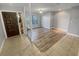 Open-concept living room featuring modern flooring, ample natural light, and a decorative entry door with stained glass at 3184 Wessex Way, Clearwater, FL 33761