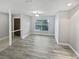 Bright living room with large window, modern flooring, and neutral paint, showing a welcoming and updated space at 3184 Wessex Way, Clearwater, FL 33761