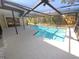 Backyard view with a screen-enclosed pool and patio area, providing a serene oasis at 3184 Wessex Way, Clearwater, FL 33761