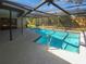 Screened pool with beautiful blue water, concrete patio, and landscaped backyard for outdoor entertainment at 3184 Wessex Way, Clearwater, FL 33761
