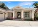 Front view of house featuring a covered entryway and landscaping at 2513 Andrea Lynn Dr, Lutz, FL 33549