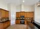 Kitchen boasts wood cabinets, granite countertops, and stainless steel appliances at 2513 Andrea Lynn Dr, Lutz, FL 33549