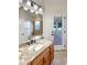 Bathroom with granite vanity, updated fixtures, and access to backyard at 2513 Andrea Lynn Dr, Lutz, FL 33549