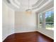 Formal dining room with hardwood floors, crown molding, and chandelier at 2513 Andrea Lynn Dr, Lutz, FL 33549