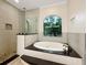 Spa-like bathroom with a soaking tub and walk-in shower at 2513 Andrea Lynn Dr, Lutz, FL 33549