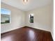 Simple bedroom with hardwood floors and ample natural light at 2513 Andrea Lynn Dr, Lutz, FL 33549