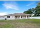 Back of house with covered patio, fenced yard, and grassy area at 2513 Andrea Lynn Dr, Lutz, FL 33549