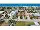 Aerial view of a beachfront property with ocean views and neighboring houses at 2504 Hibiscus W Dr, Belleair Beach, FL 33786